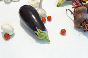 Eggplant with champignons, garlic, beets and tomatoes on white background. Horizontal.