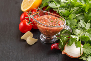 Traditional mexican red spicy sauce salsa with ingredients