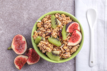 Bowl of homemade granola with fresh bananas and figs