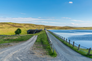Fototapeta na wymiar Rural road in Wales, leading to the dam at the Aled Isaf Reservoir, Conwy, Wales, UK