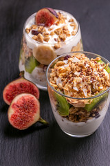 Granola with yogurt, bananas and figs. Copy space
