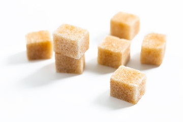 Food Spot focus organic Brown sugar cane cubes on white background