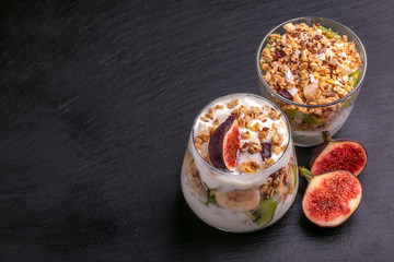 Granola with yogurt, bananas and figs. Copy space