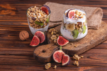 Granola with yogurt, bananas and figs. Copy space