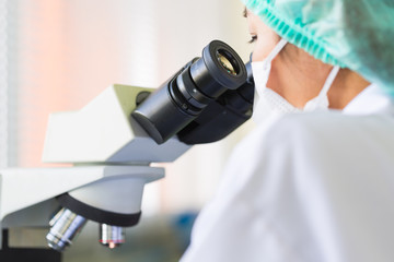 Scientist using a microscope in a laboratory, Concept science and Technology