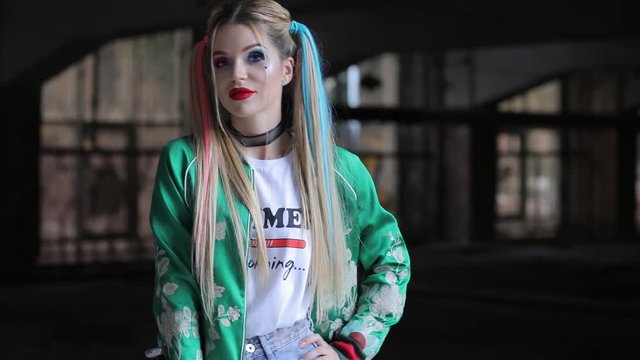 Unusual woman with fantastic makeup and unconventional hairstyle holding baseball-bat