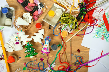 Fototapeta premium Handmade decorations for new year and other holidays. Artwork workplace with creative accessories.