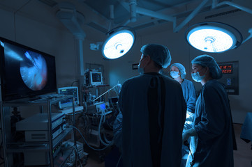 group of veterinarian surgery in operation room take with art lighting and blue filter