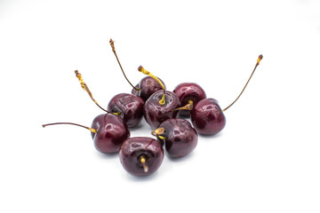 Ripe red fresh cherry on a white isolated background.