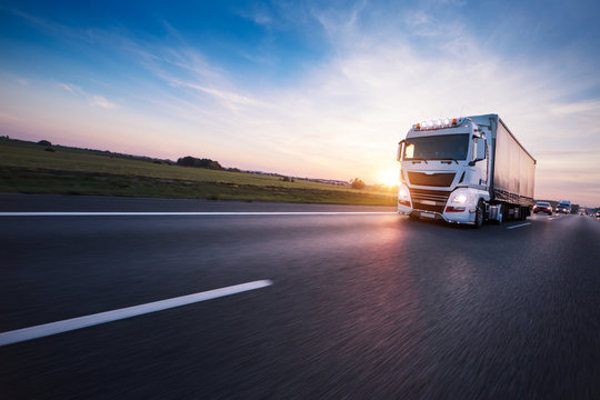 Fototapeta Loaded European truck on motorway in sunset