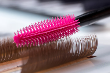 Eyelash brown extension procedure. Set Lashes close up pink comb