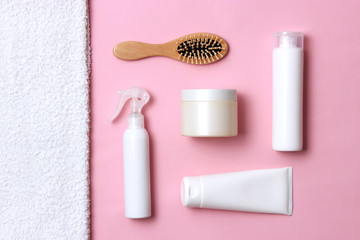 cosmetic for hair care, comb and towel on a colored background top view. flatlay 