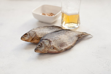 Two dried fish crucian beer and nuts in a bowl