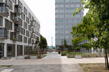 alley in the city center between buildings and vegetation