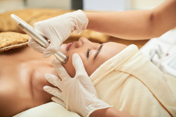 Obraz na płótnie Canvas Process of professional facial lymphatic drainage massage