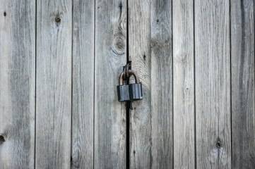 Old lock on the door. lock on the door of an old farmhouse . true village style