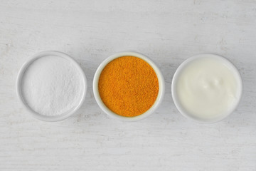 Obraz na płótnie Canvas Homemade face mask made out of rice flour, turmeric and yogurt
