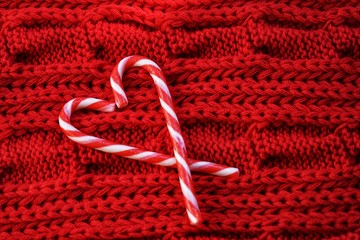 New Year on Valentines day , Candy canes,cinnamon stick in a heart shape on a wooden background and...
