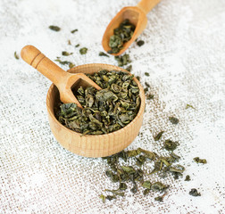 aromatic green dry tea on light coloured white