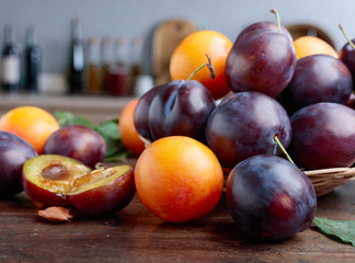 Ripe juicy plums on a kitchen table.