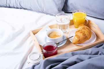 morning breakfast bed wooden tray coffee croissant