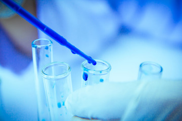 Close up.  Medical or male medical in  laboratory room research performs tests with blue liquid, Experimental Drug Treatment