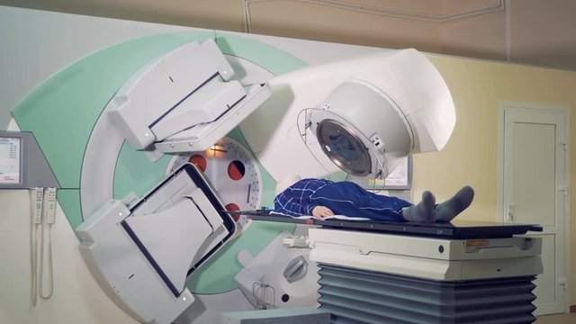 Linear accelerator is radiating a patient in treatment process. Modern medicine concept.