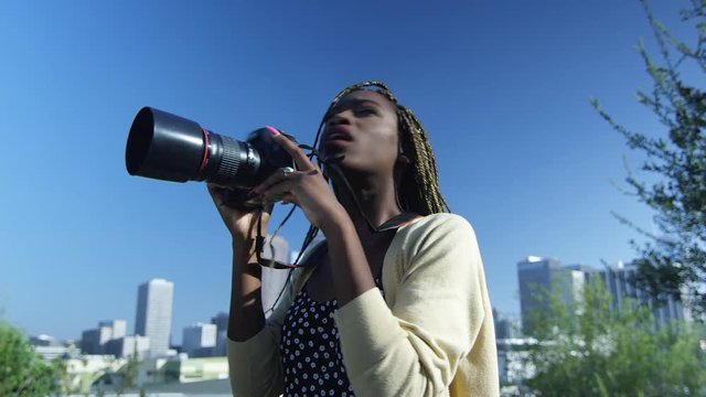 Slow motion of black woman taking pictures in Los Angeles