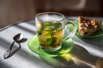 A cup of green mint tea on the table