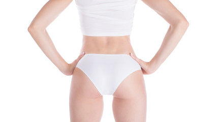 Female well groomed cropped fit buttocks and back in base white underwear, isolated on white.