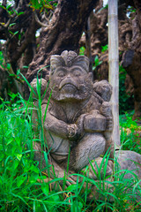 Obraz premium Indonesian historical statue nearby the beach of the Bali island, Indonesia. Bali is an Indonesian island and known as a tourist destination. In Bali, rice harvest seasons come three times in a year.