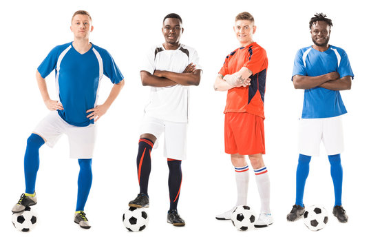 confident young multiethnic soccer players standing with balls and looking at camera isolated on white - Powered by Adobe