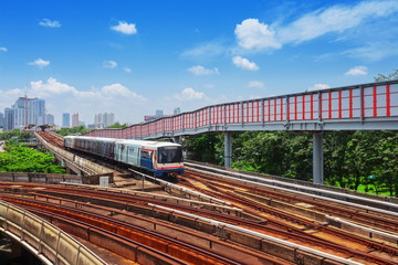 Trains traveling on elevated rails of BTS Metro System Thailand, Bangkok mass rapid train (MRT) travels on the track.