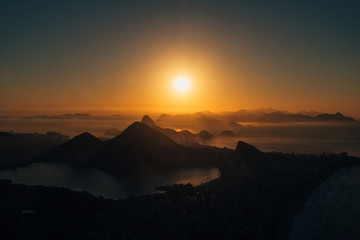 Brazil, Rio de Janeiro. Meeting the dawn on the hill Two brothers. View of the big city, lake, ocean, hills, mountains. Orange-blue colors