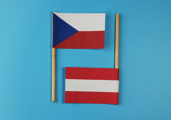 A czech national flag with flag of austria on wooden sticks
