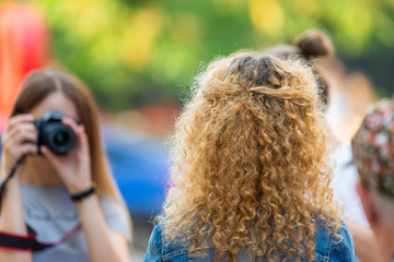 Two beauty womens make a photo session on street