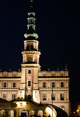 Fototapeta na wymiar Town Hall, an old medieval building in the city of Zamosc in night. Idea for poster, postcard