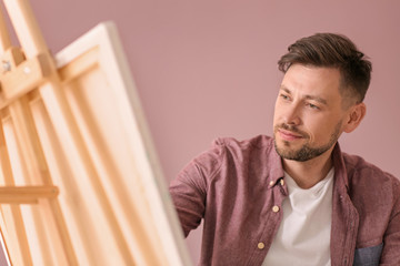 Fototapeta premium Male artist painting in workshop