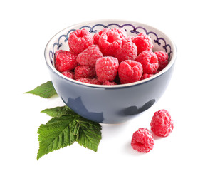Bowl with ripe raspberries on white background
