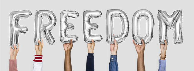 Silver gray alphabet balloons forming the word freedom