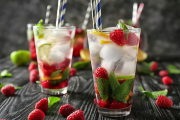 Glasses of fresh raspberry mojito on wooden table