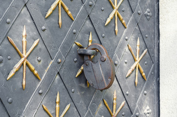 Large metal lock on the ancient door of the Catholic church