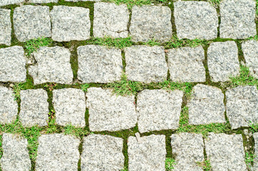 Ancient granite sidewalk tile.