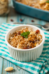 Traditional, mexican baked sweet rice, with almonds, raisins and walnuts.