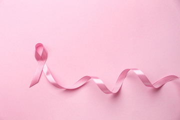 Pink ribbon on color background. Breast cancer concept