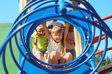 Cute little children having fun on playground outdoors