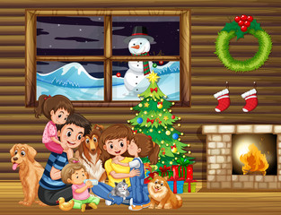 Family sitting in front of christmas tree