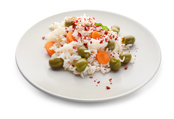 Plate with tasty boiled rice and vegetables on white background