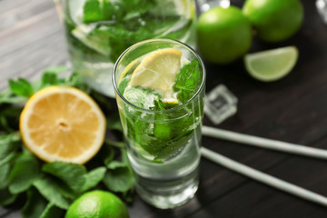 Glass of fresh mojito on wooden table