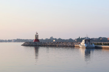 The boat of police or coastal guard moored nier the pier.